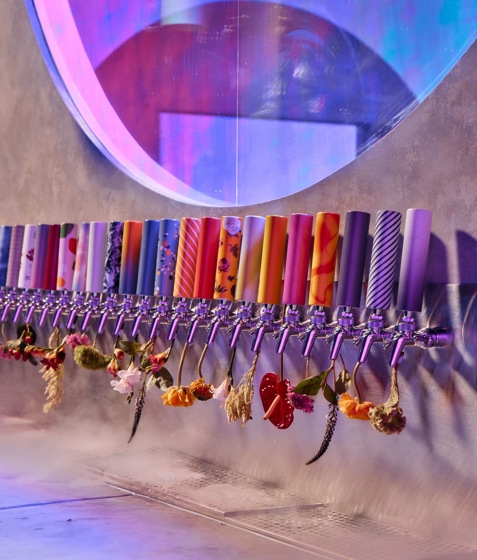 Wandering Barman tap wall with floral handles and colourful taps