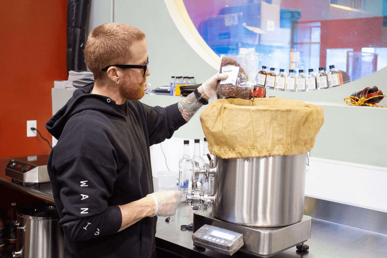 Wandering Barman production lab — cocktail technician adding ingredients to a batch